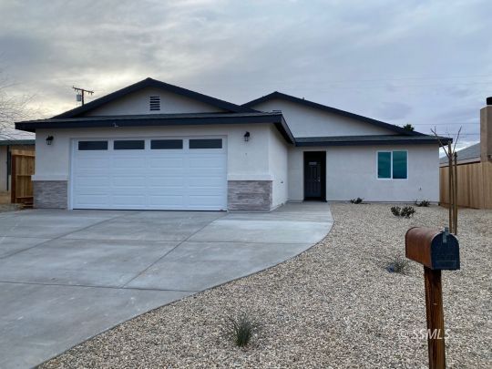 1419 Sims Street Ridgecrest, CA 93555 - Photo 1 of 17 a front view of a house with garden
