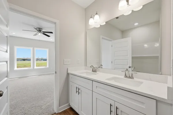 a bathroom with a sink a chandelier and a mirror