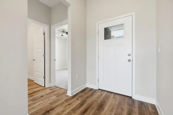 a view of a room with wooden floor