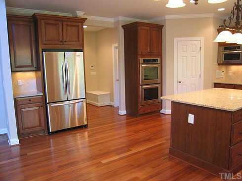 7409 Chesley Lane Durham, NC 27713 - Photo 3 of 10 a kitchen with granite countertop stainless steel appliances a refrigerator and cabinets