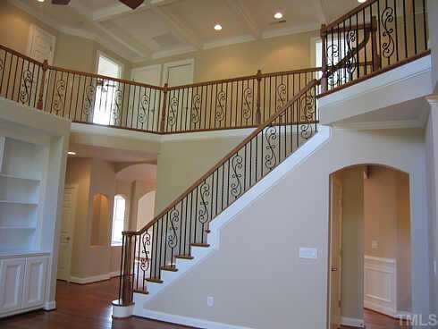 7409 Chesley Lane Durham, NC 27713 - Photo 6 of 10 a view of staircase with railing and a chandelier