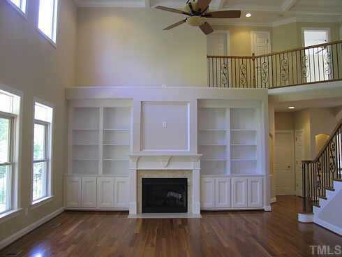 7409 Chesley Lane Durham, NC 27713 - Photo 7 of 10 an entryway with a livingroom fireplace and wooden floor