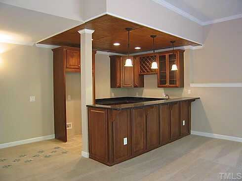 7409 Chesley Lane Durham, NC 27713 - Photo 8 of 10 a view of a hallway with wooden floor and a front door