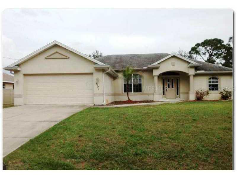 6121 Surf Avenue North Port, FL 34291 - Photo 1 of 1 a front view of a house with a yard and garage