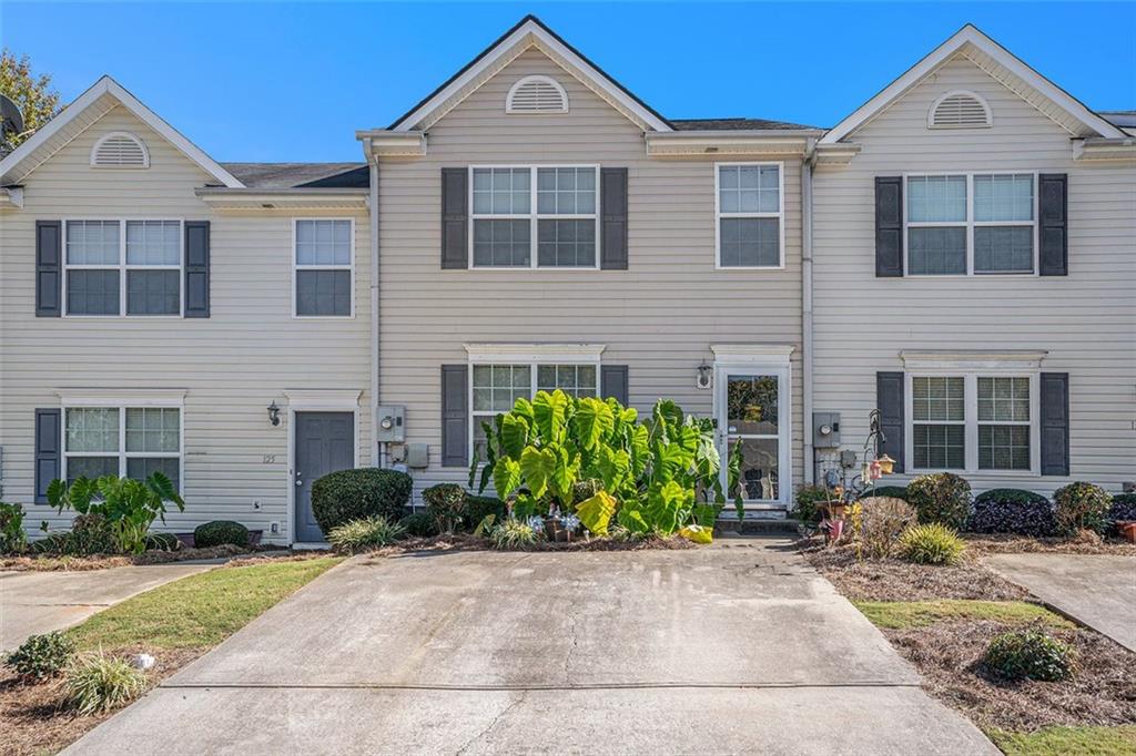 123 Chastain Circle Newnan, GA 30263 - Photo 1 of 1 a front view of a house with garden