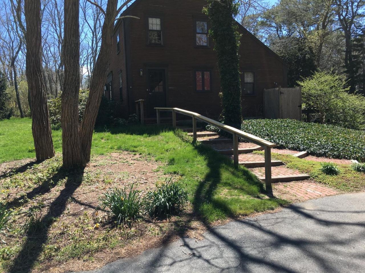 35 Split Rail Road Eastham, MA 02642 - Photo 26 of 28 a park view with a bench in backyard