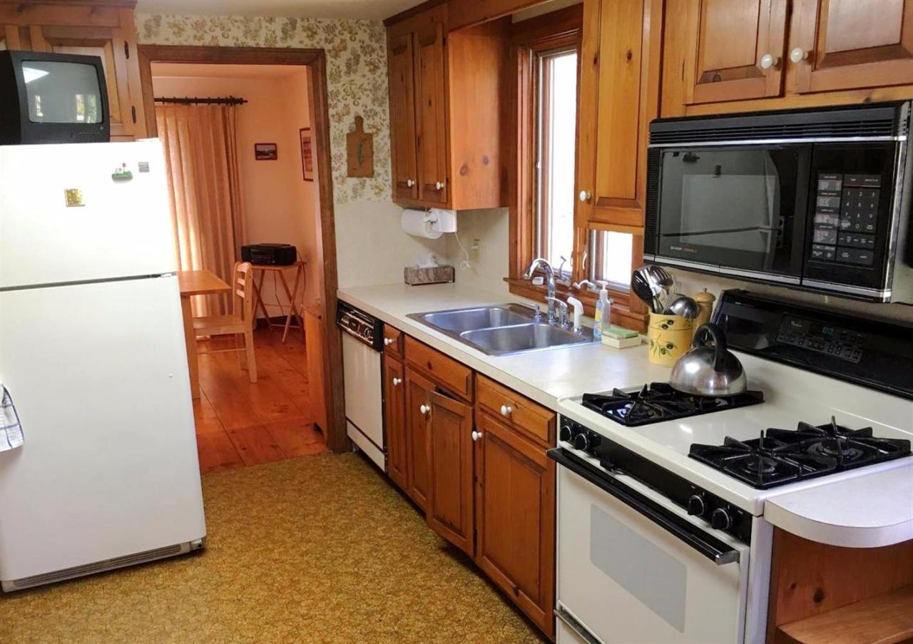 35 Split Rail Road Eastham, MA 02642 - Photo 7 of 28 a kitchen with stainless steel appliances a stove a sink and a refrigerator