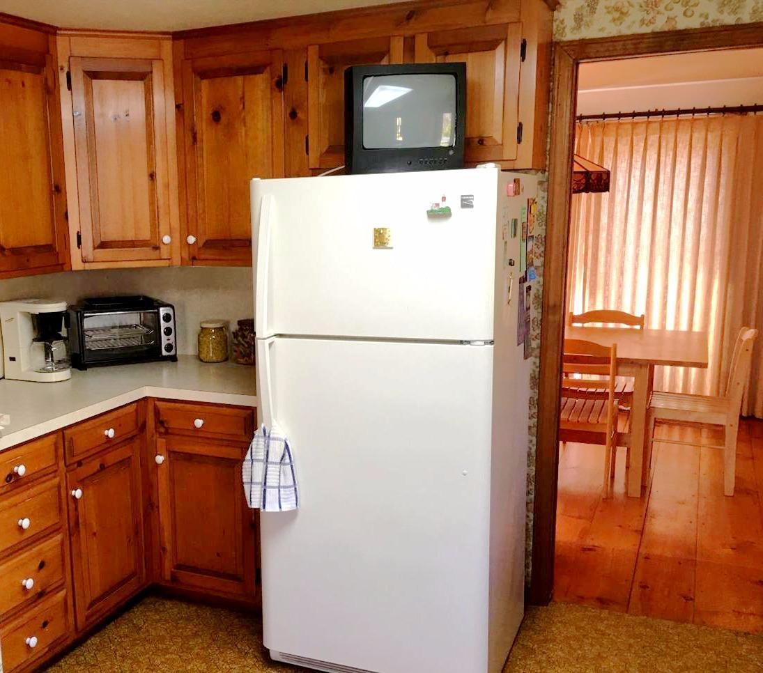 35 Split Rail Road Eastham, MA 02642 - Photo 8 of 28 a kitchen with a refrigerator and a sink