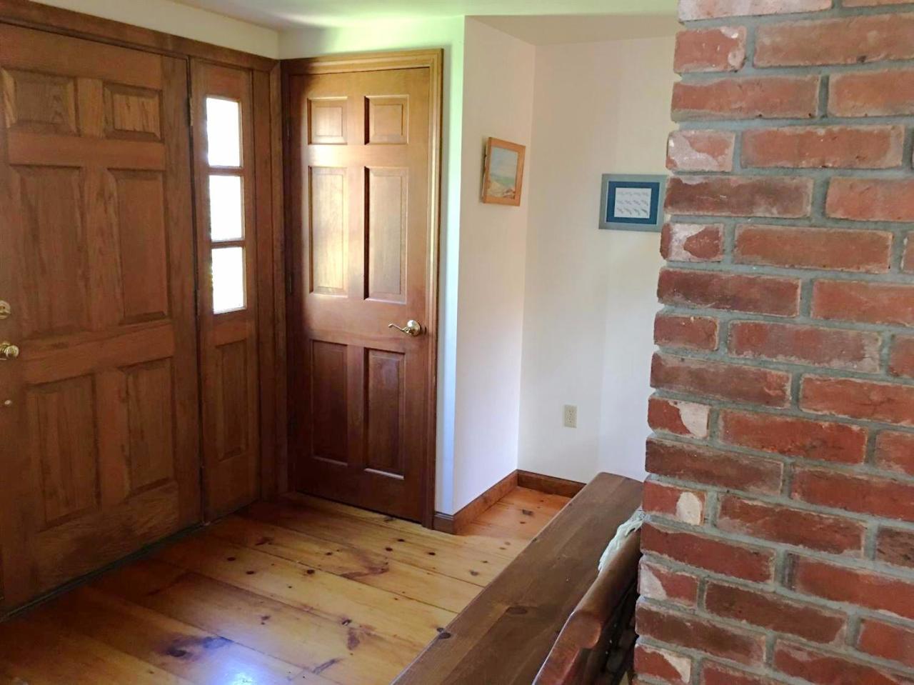 35 Split Rail Road Eastham, MA 02642 - Photo 10 of 28 a view of a bedroom with wooden floor and windows