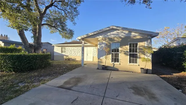 a view of a house with a yard and tree s