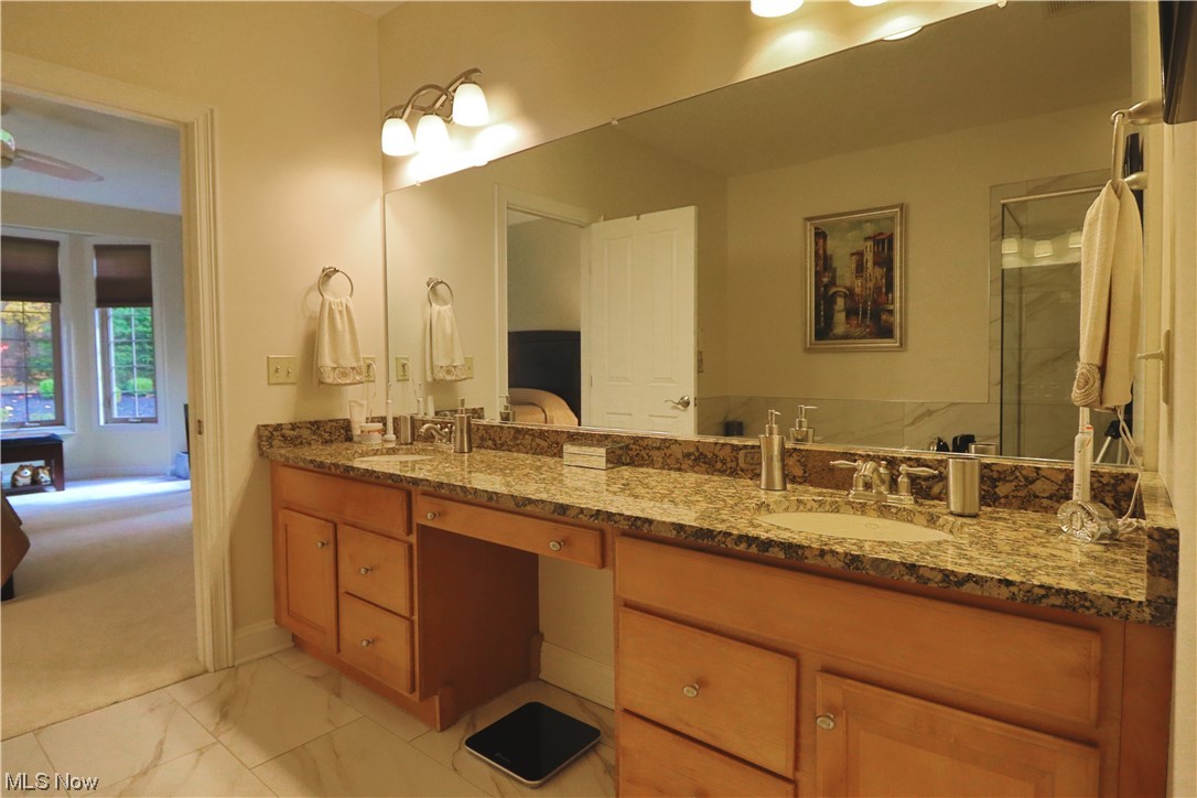8257 Morley Road Mentor, OH 44060 - Photo 20 of 35 Bathroom featuring porcelin tile floors, ceiling fan, and dual vanity