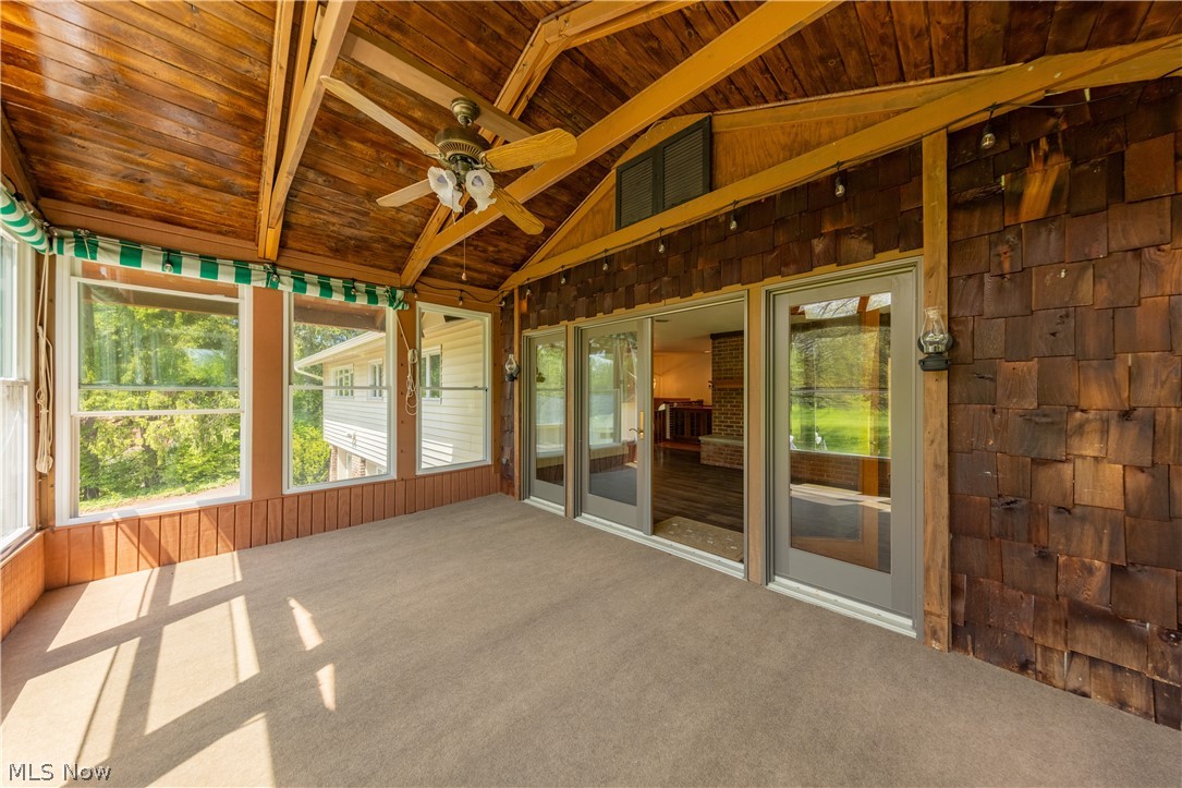 7969 Dines Road Novelty, OH 44072 - Photo 17 of 48 Sun room featuring a vaulted wood-plank ceiling, exposed wood beams, and a ceiling fan with integrated lighting
