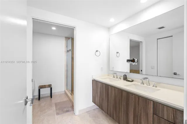 a bathroom with a sink double vanity and a mirror