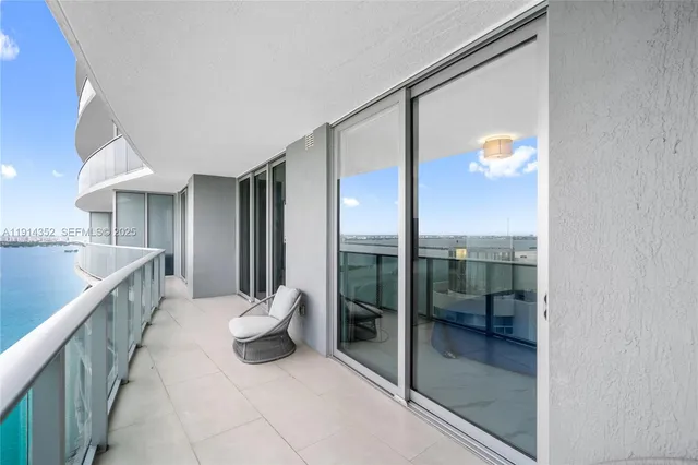 a view of a room with shelves and stairs