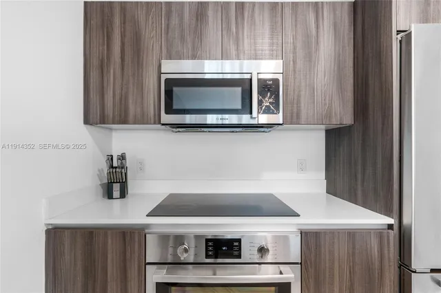 a stove top oven sitting inside of a kitchen