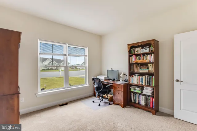 a work room with furniture and a book shelf