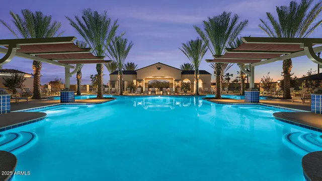 a view of a swimming pool with a table and chairs under an umbrella