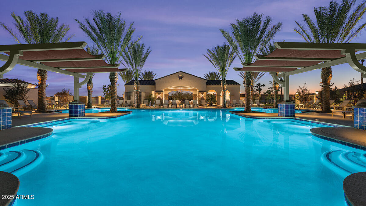 2029 North 164th Avenue Goodyear, AZ 85395 - Photo 11 of 17 a view of a swimming pool with a table and chairs under an umbrella