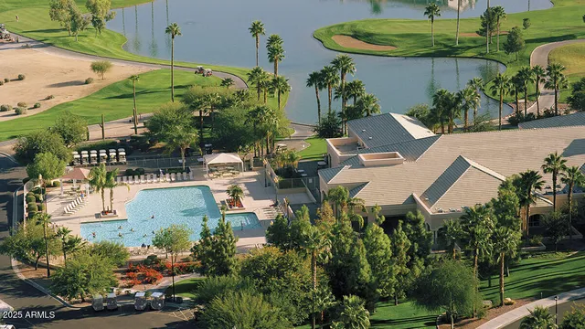 an aerial view of a house with a yard and outdoor seating