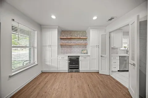 a kitchen with a refrigerator a table and chairs
