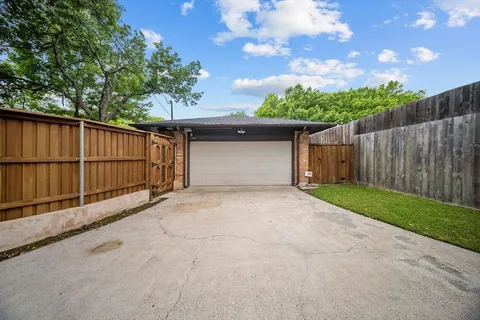 a view of a backyard with a tree