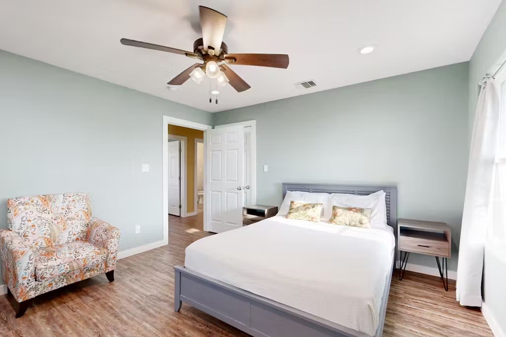 370-374 Copano Ridge Road Rockport, TX 78382 - Photo 14 of 40 a bedroom with a bed and wooden floor