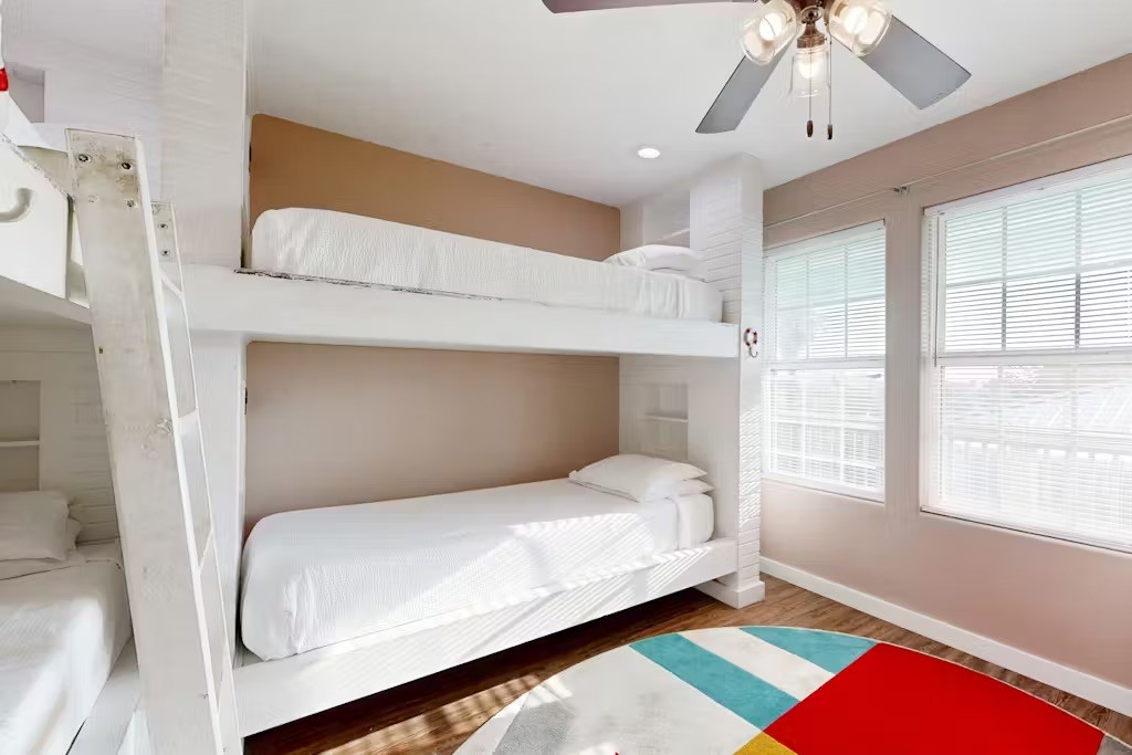 370-374 Copano Ridge Road Rockport, TX 78382 - Photo 17 of 40 a bedroom with a bed and a window