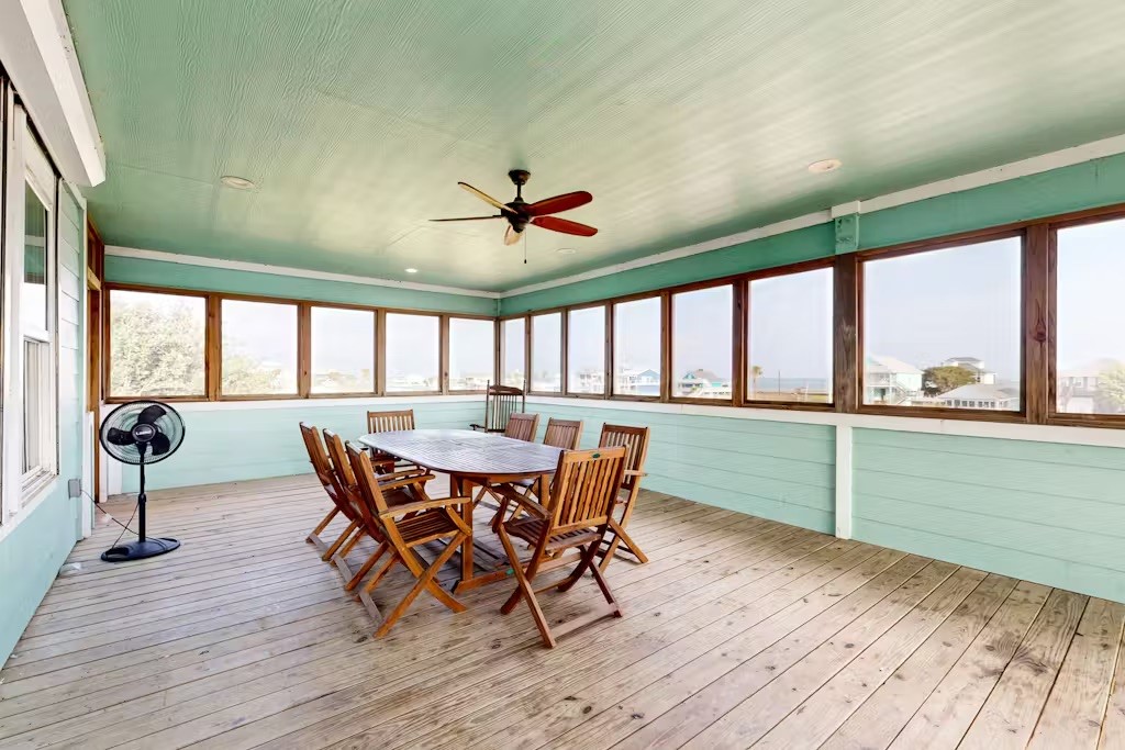 370-374 Copano Ridge Road Rockport, TX 78382 - Photo 20 of 40 a view of a dining room with furniture large windows and wooden floor