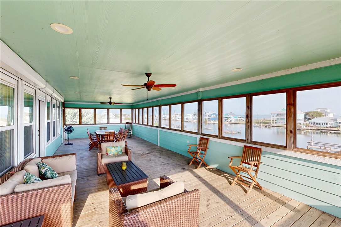 370-374 Copano Ridge Road Rockport, TX 78382 - Photo 21 of 40 a living room with furniture and a floor to ceiling window