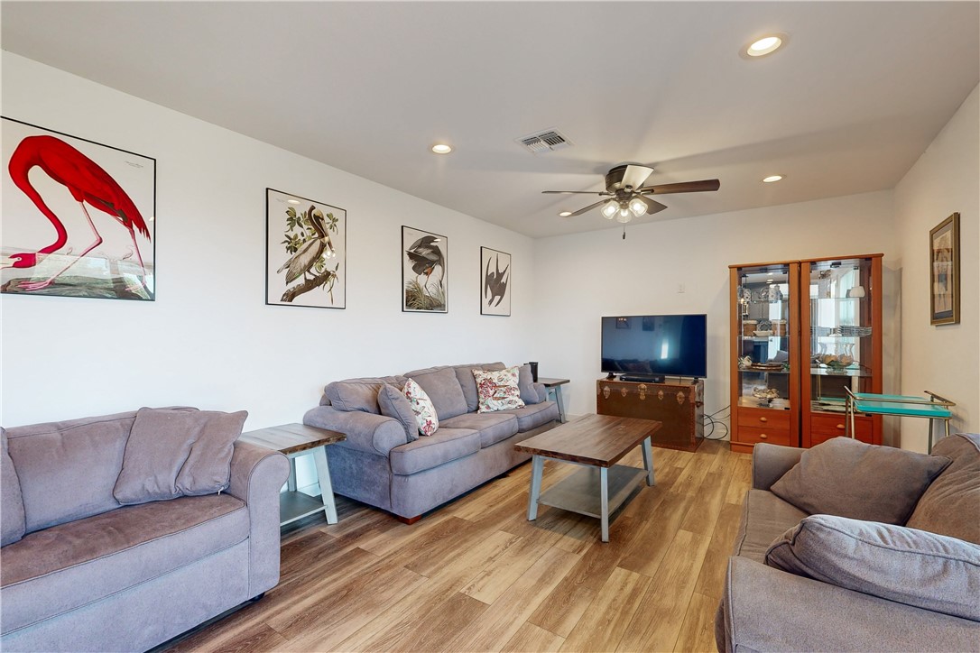 370-374 Copano Ridge Road Rockport, TX 78382 - Photo 29 of 40 a living room with furniture and a flat screen tv