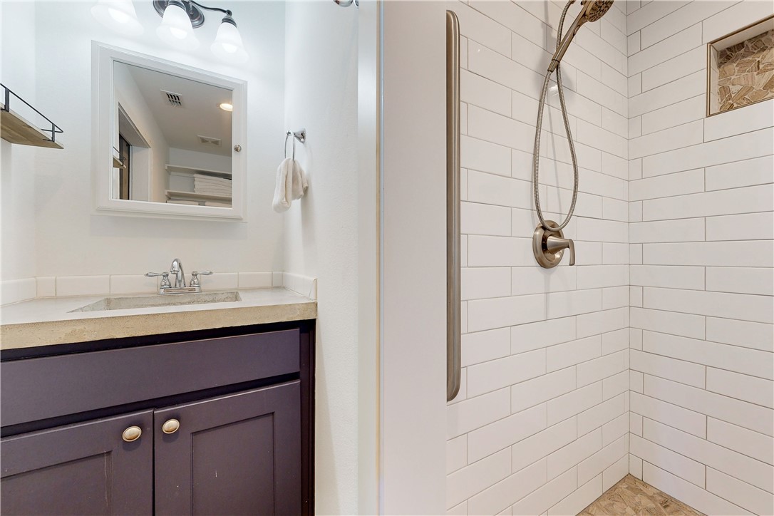 370-374 Copano Ridge Road Rockport, TX 78382 - Photo 35 of 40 a bathroom with a sink and a mirror