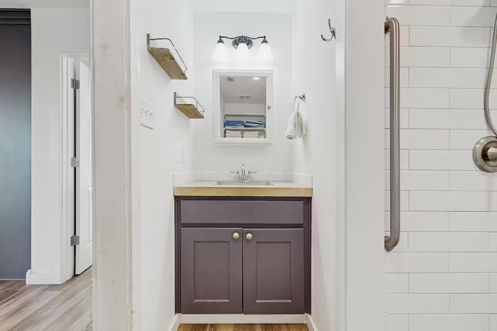 370-374 Copano Ridge Road Rockport, TX 78382 - Photo 36 of 40 a bathroom with a granite countertop sink and a mirror