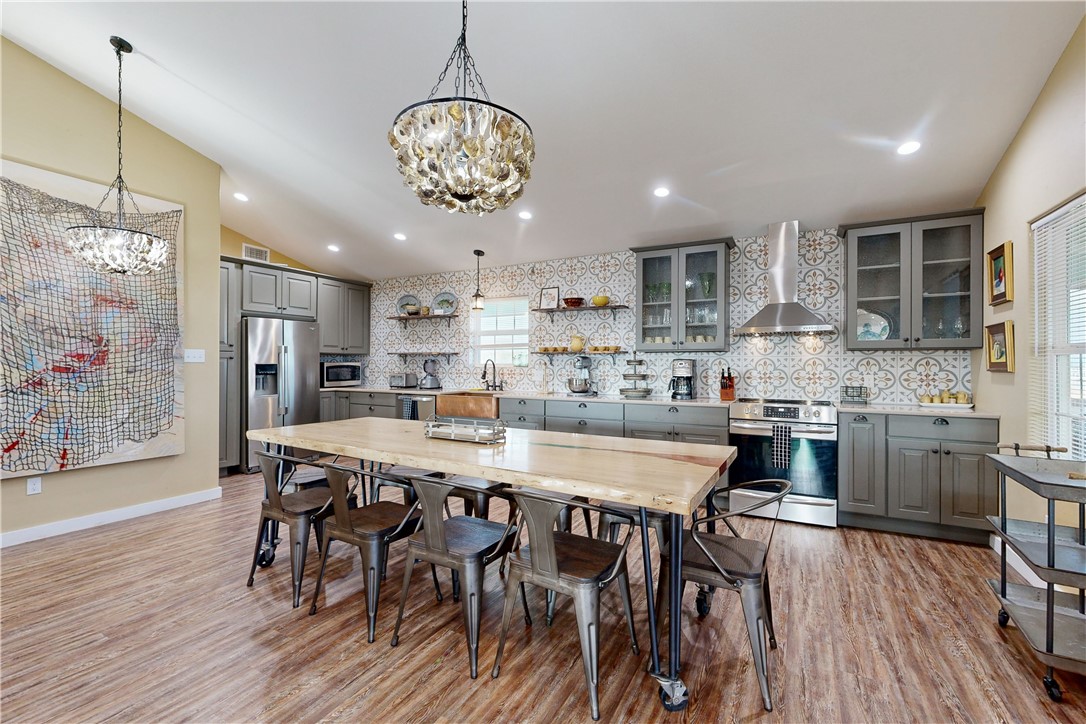 370-374 Copano Ridge Road Rockport, TX 78382 - Photo 6 of 40 a large kitchen with a table and chairs