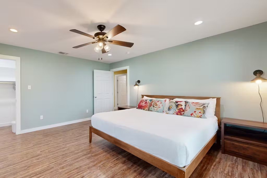 370-374 Copano Ridge Road Rockport, TX 78382 - Photo 10 of 40 a bedroom with a bed and a ceiling fan