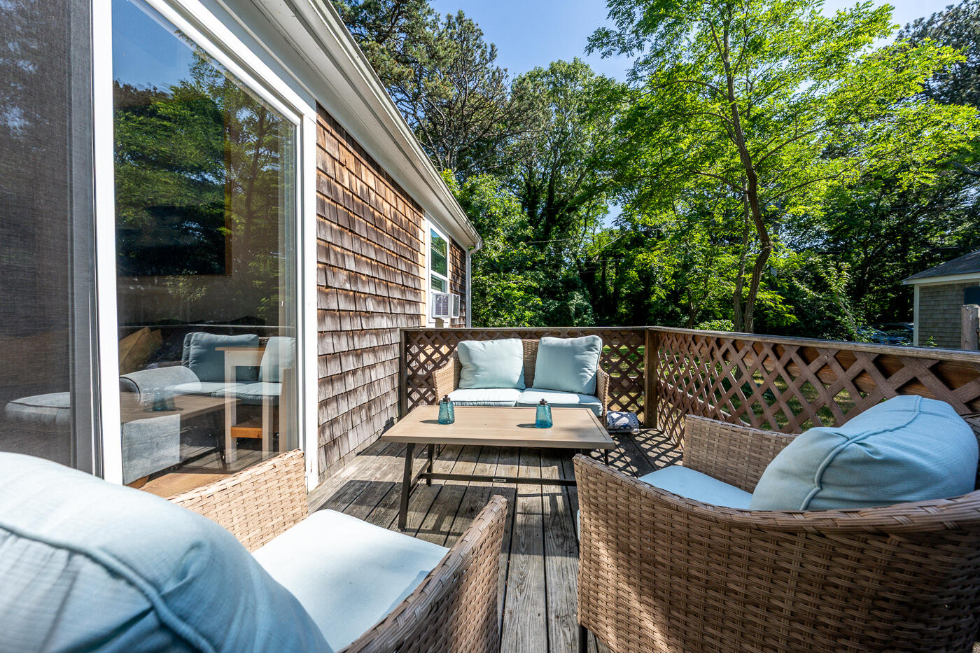 60 Long Avenue, Unit E Wellfleet, MA 02667 - Photo 16 of 18 a balcony with wooden floor and outdoor seating