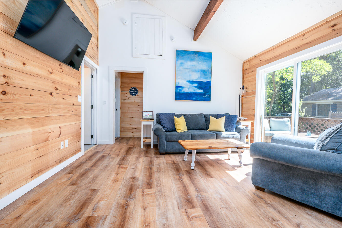 60 Long Avenue, Unit E Wellfleet, MA 02667 - Photo 5 of 18 a living room with furniture and a floor to ceiling window