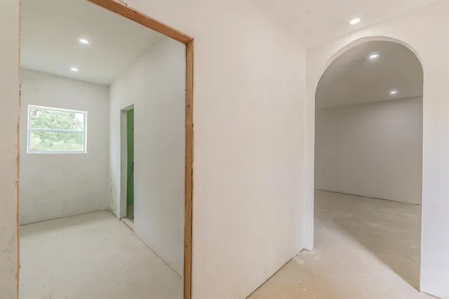 an empty room with windows and closet