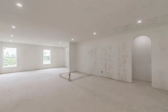 an empty room with a empty space and windows