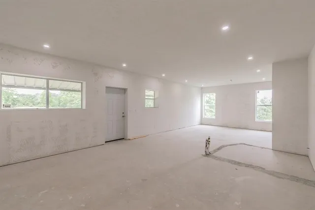 an empty room with windows and closet