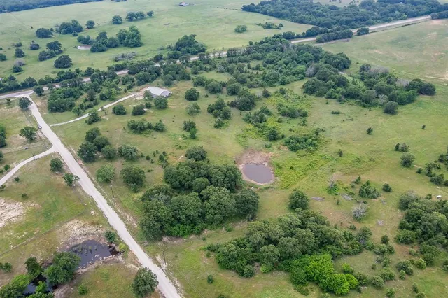 an aerial view of a house with a yard