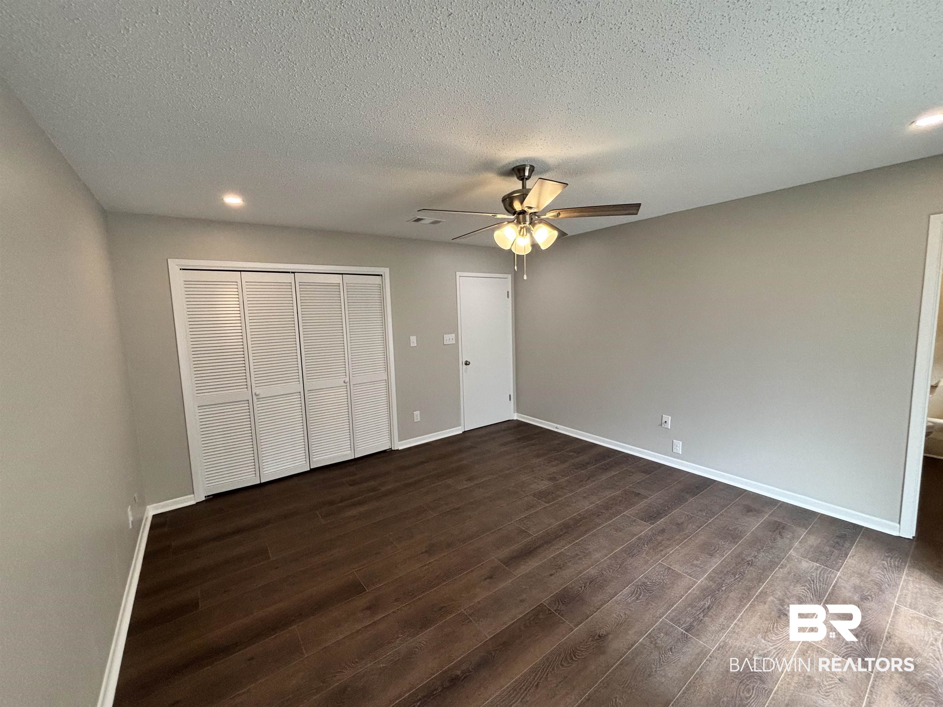 10 Soldiers Route Daphne, AL 36527 - Photo 18 of 26 Unfurnished bedroom featuring recessed lighting, a closet, ceiling fan, a textured ceiling, and dark wood-style flooring
