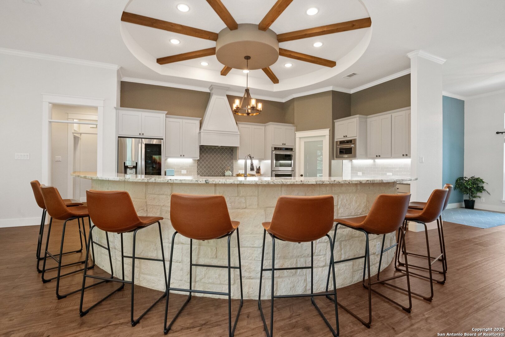 10015 Kopplin Road New Braunfels, TX 78132 - Photo 11 of 38 a view of a dining room with furniture and wooden floor