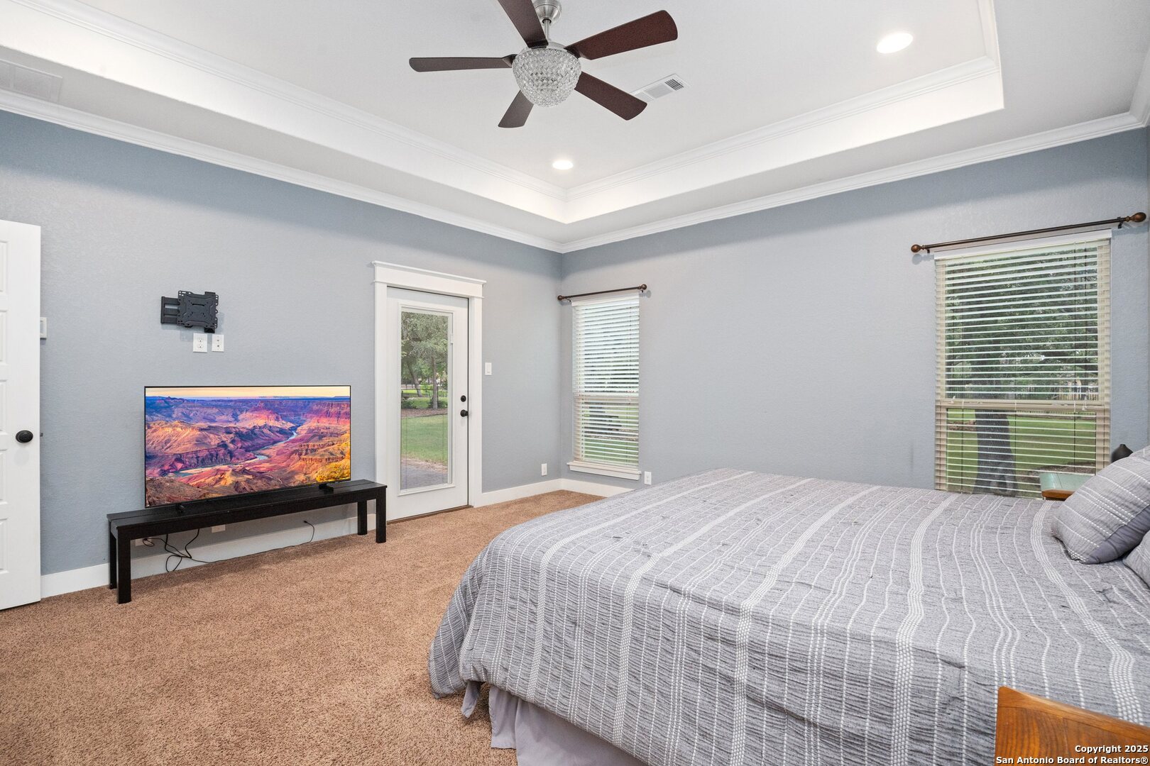 10015 Kopplin Road New Braunfels, TX 78132 - Photo 20 of 38 a bedroom with furniture window and flat screen tv