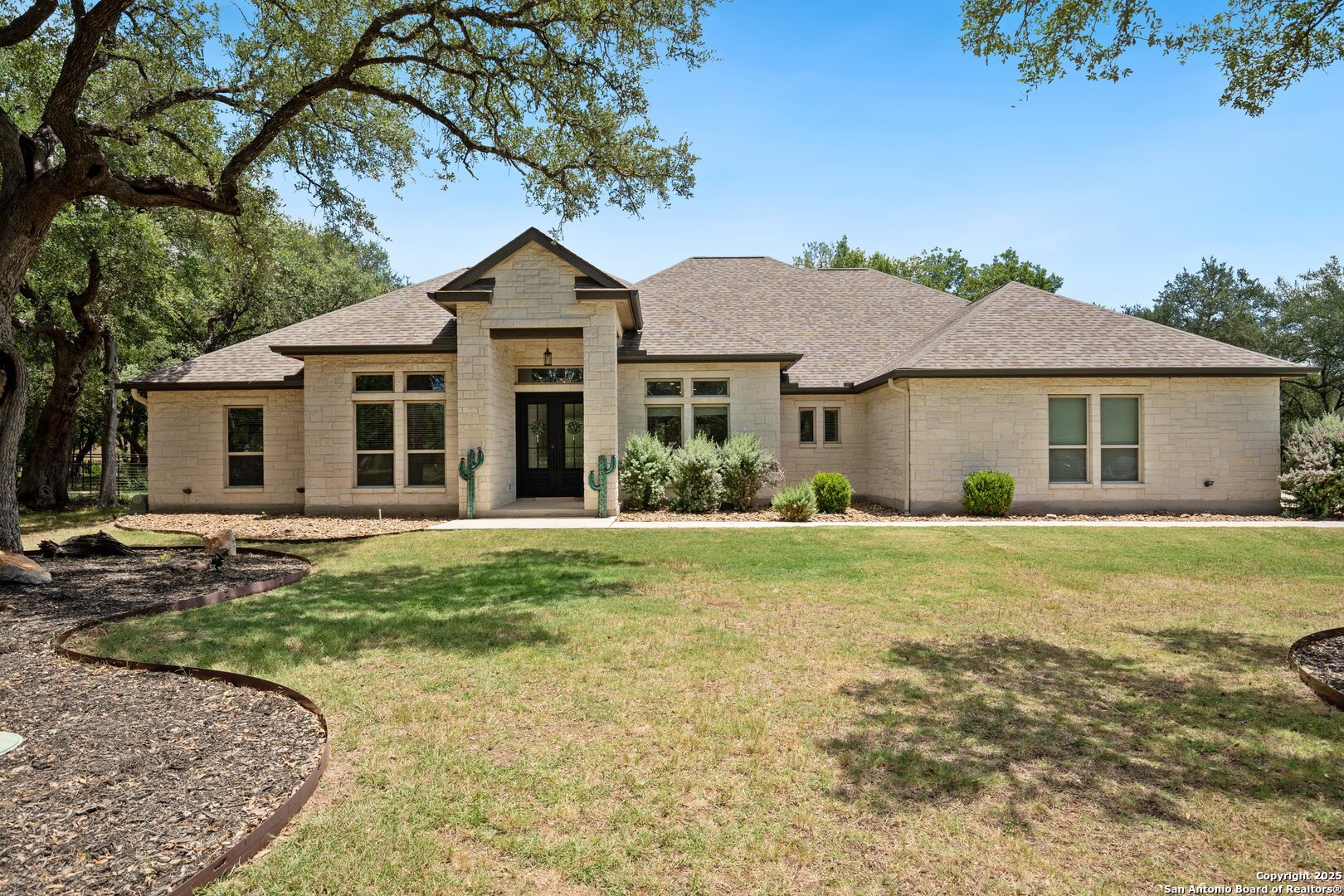 10015 Kopplin Road New Braunfels, TX 78132 - Photo 2 of 38 a front view of a house with a garden