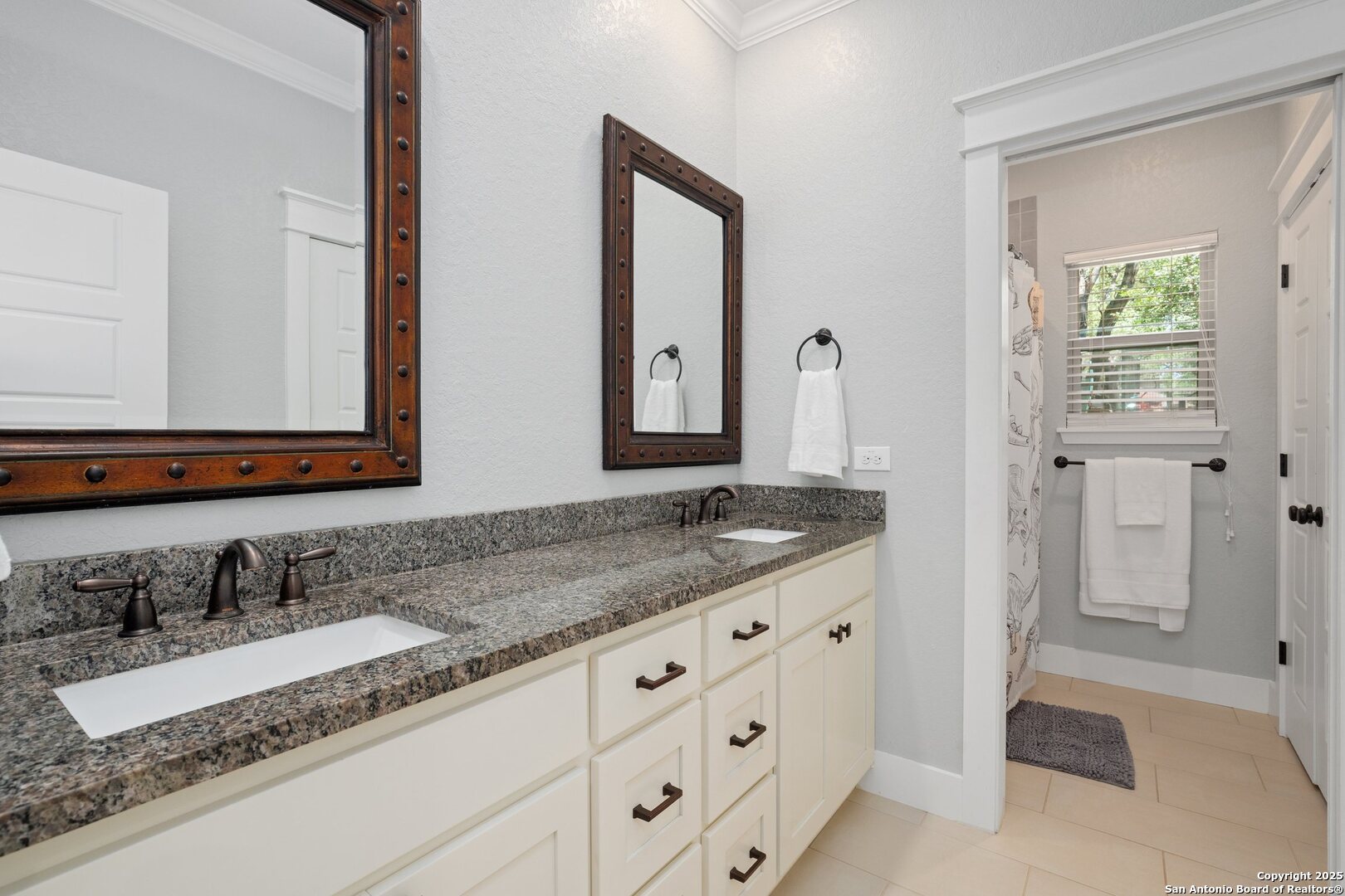 10015 Kopplin Road New Braunfels, TX 78132 - Photo 23 of 38 a bathroom with double sink and a mirror