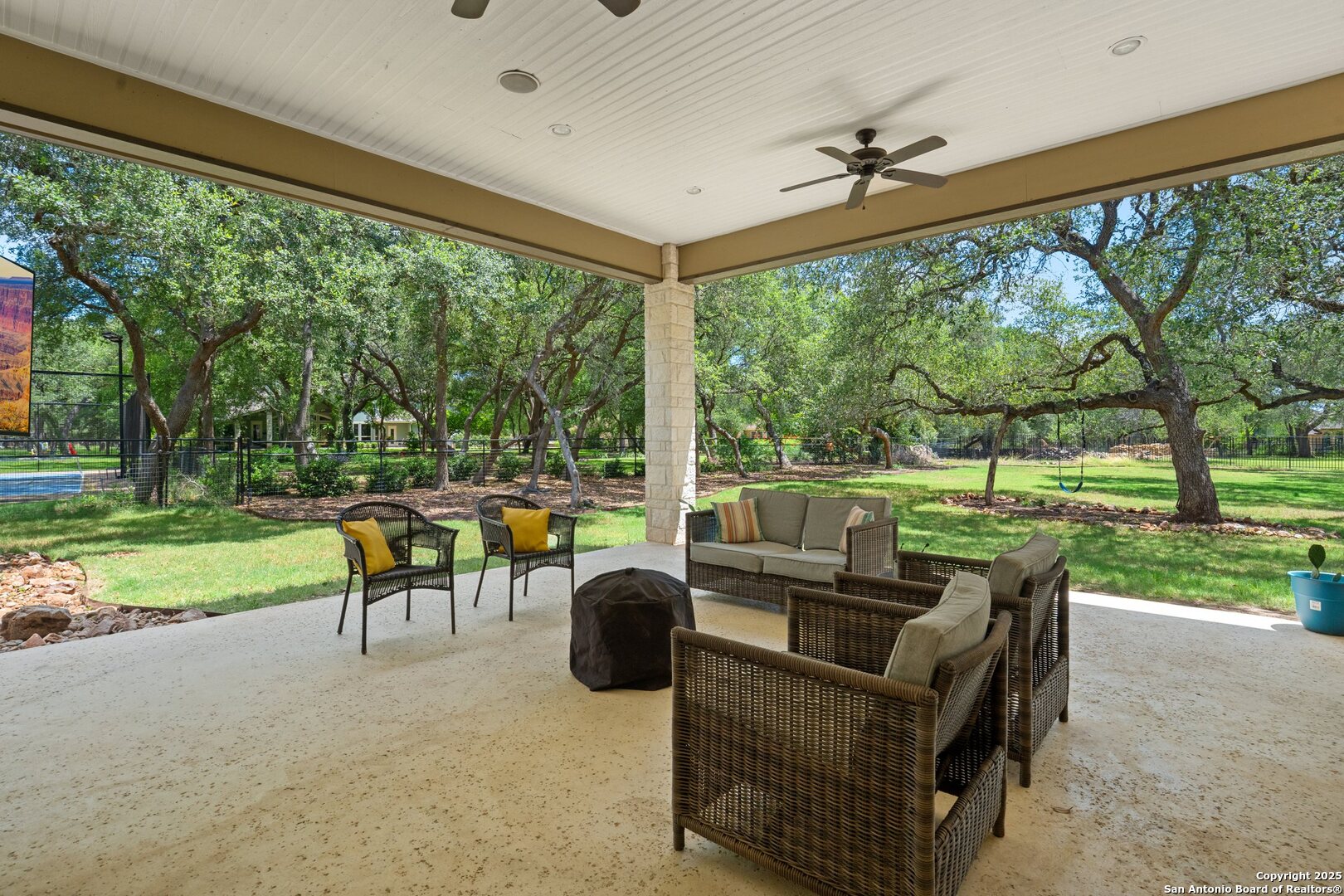 10015 Kopplin Road New Braunfels, TX 78132 - Photo 29 of 38 a view of a patio with couches chairs and a big yard