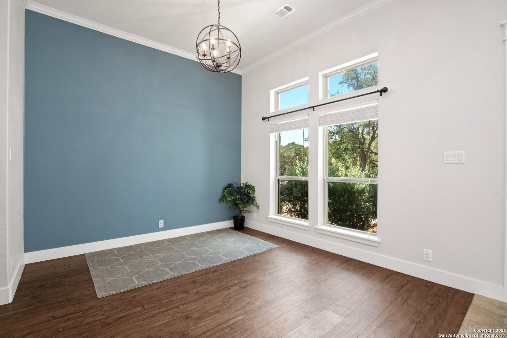 10015 Kopplin Road New Braunfels, TX 78132 - Photo 5 of 38 an empty room with wooden floor and windows