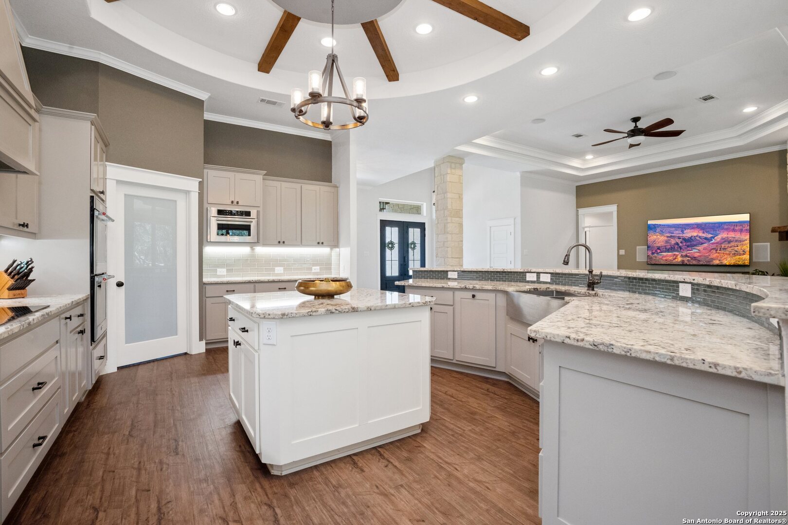10015 Kopplin Road New Braunfels, TX 78132 - Photo 10 of 38 a kitchen with kitchen island granite countertop a sink appliances and cabinets