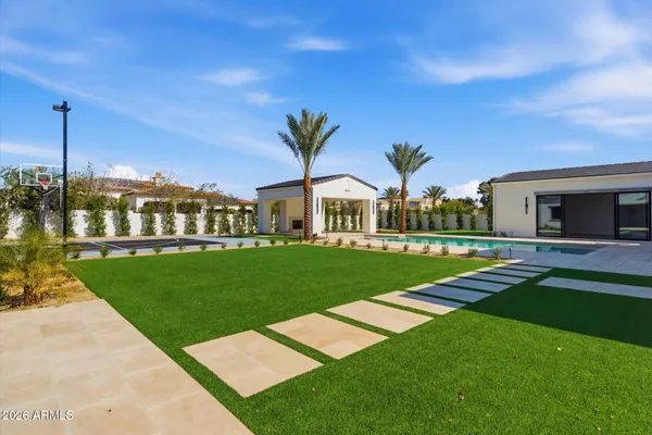 a view of hall way with furniture and chandelier