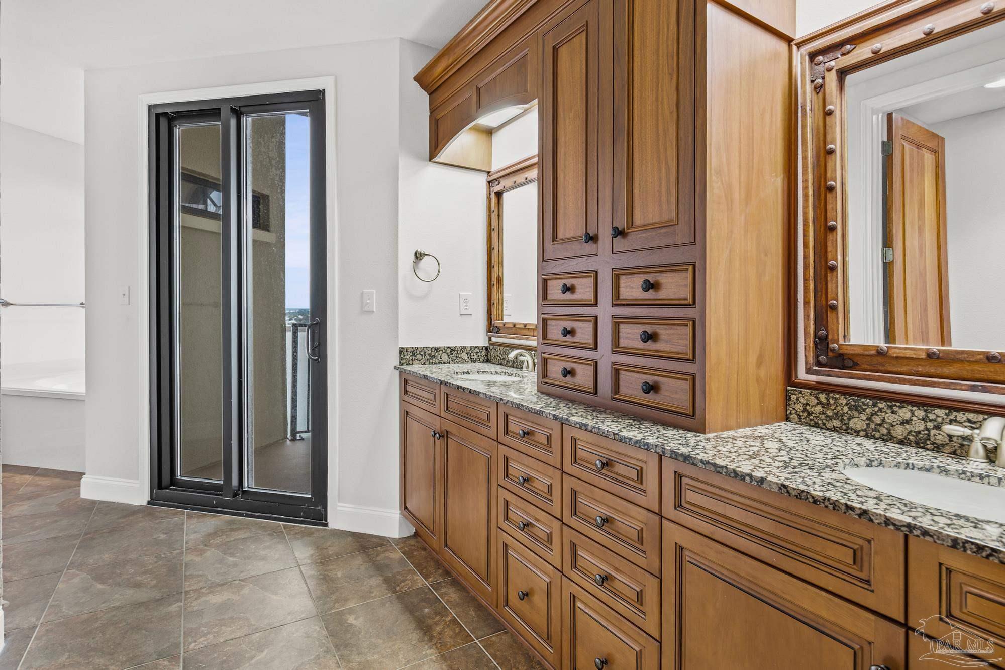 14900 River Road, Unit 904 Perdido Key, FL 32507 - Photo 26 of 62 a bathroom with a granite countertop sink and a mirror